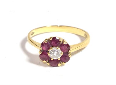 Lot 226 - An 18 carat gold ruby and diamond cluster ring, finger size L