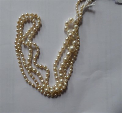 Lot 258 - A graduated single row cultured pearl necklace with a diamond set clasp, length 102cm (a.f.);...