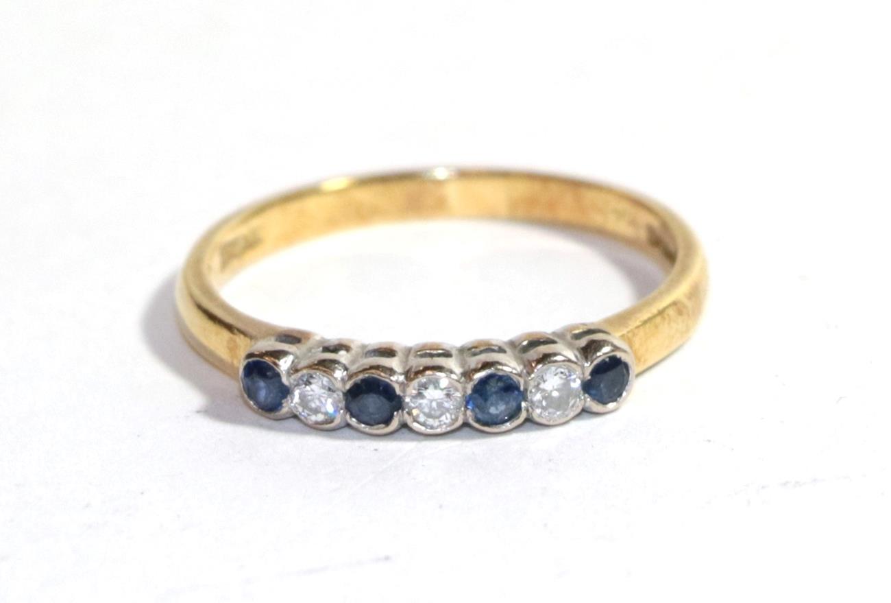Lot 270 - An 18 carat gold sapphire and diamond seven stone ring, finger size O1/2