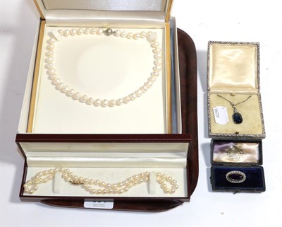 Lot 304 - A cultured pearl necklace with 9 carat gold clasp, length 48cm; a blue and white stone paste...