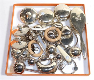 Lot 305 - A group of Elizabeth II silver child's-items, including: ten various rattles, some with wood or...