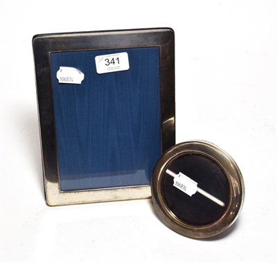 Lot 341 - Two Elizabeth II silver photograph frames, one oblong and one round