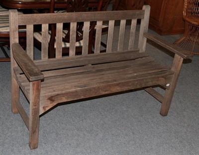Lot 1100 - A wooden slatted garden bench