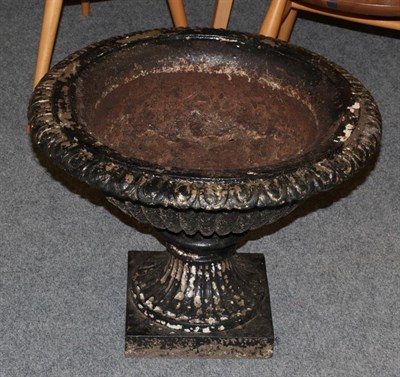 Lot 1101 - A black painted cast iron campana shaped garden urn 42cm by 54cm diameter