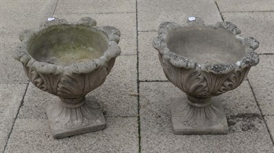 Lot 1102 - A pair of composition garden urns