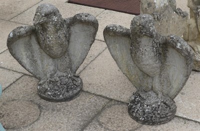 Lot 1111 - A pair of weathered composition eagles