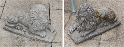 Lot 1112 - A pair of weathered composition recumbent lions