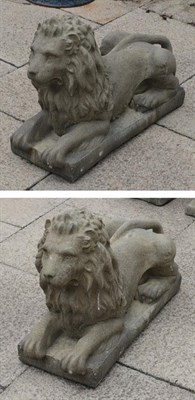 Lot 1123 - A pair of composition recumbent lions