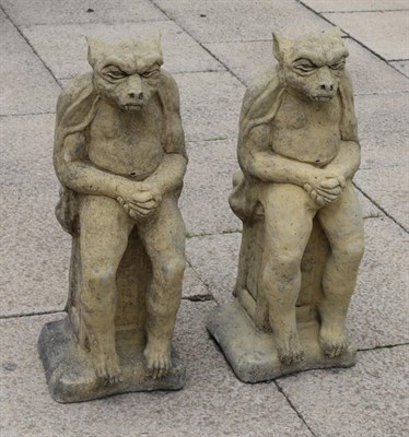 Lot 1126 - A pair of composition seated gargoyles