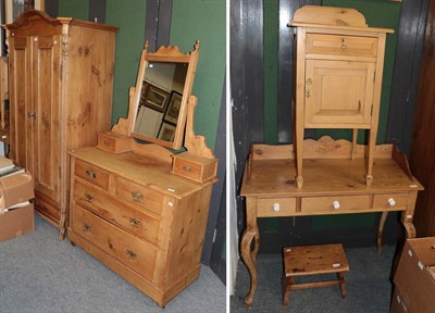 Lot 1130 - A group of pine furniture, comprising a small wardrobe, a mirrored dressing table, wash stand,...