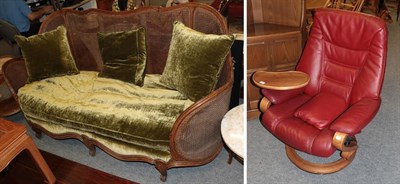 Lot 1133 - A red leather upholstered himolla revolving and reclining armchair fitted with tray table