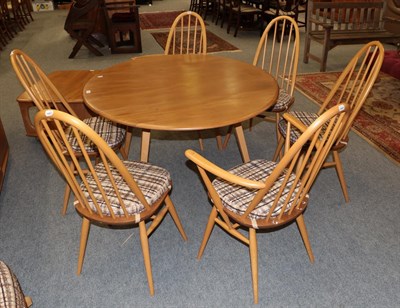 Lot 1134 - An Ercol light elm drop leaf dining table, together with a set of six matching chairs,...
