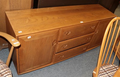 Lot 1135 - An Ercol light elm side board, the bank of three drawers, flanked by a pair of covered drawers 69cm