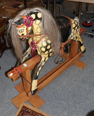 Lot 1142 - A children's painted rocking horse with horsehair mane and tail, on a trestle base