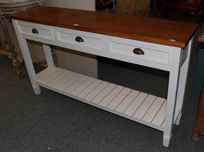 Lot 1174 - A modern white painted oak topped narrow hall table, fitted with three frieze drawers and the...