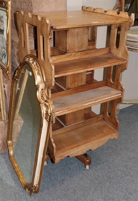 Lot 1179 - A pine revolving bookcase, together with a gilt framed mirror (2)