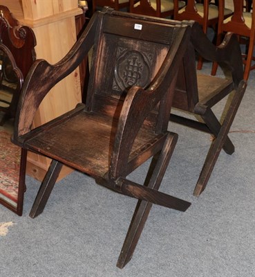 Lot 1186 - Pair of oak Glastonbury cross framed chairs, each carved with a monogram