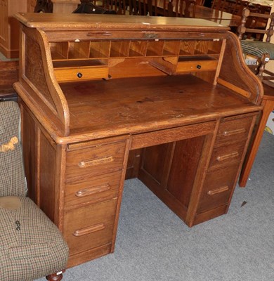 Lot 1191 - An early 20th century oak roll top desk, 113cm by 121cm by 65cm