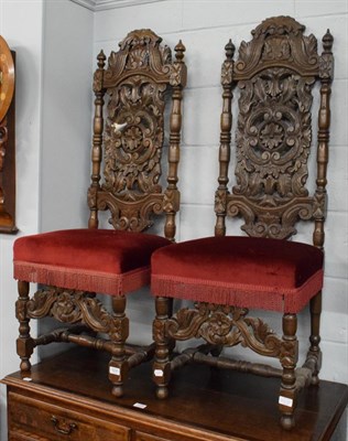 Lot 1231 - A pair of Victorian carved oak hall chairs