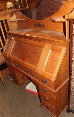 Lot 1247 - An early 20th century Arts & Crafts oak forefront kneehole desk 'The Britisher desk' 145cm by 122cm