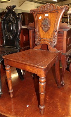 Lot 1256 - An 19th century Scottish carved oak hall chair bearing the crest for clan Anderson