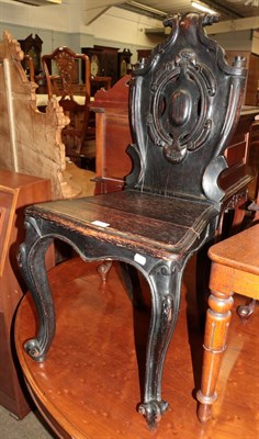 Lot 1257 - A 19th century stained oak shield back hall chair