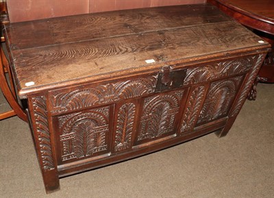 Lot 1267 - A 17th/18th century oak coffer, the twin plank moulded rectangular top above a lunette carved...