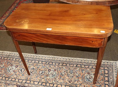 Lot 1272 - A George III inlaid mahogany fold over tea table, 74cm by 91cm by 45cm