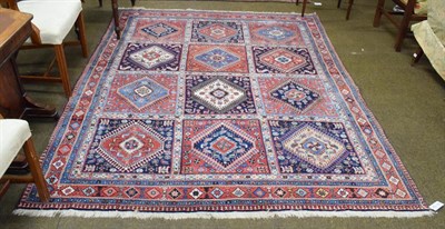 Lot 1275 - Yalameh carpet, the indigo and brick red compartmentalised field of hooked medallions enclosed...