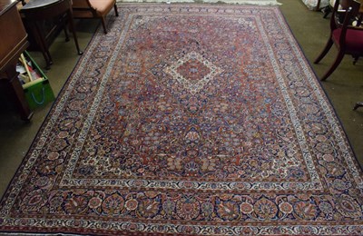 Lot 1278 - Kashan carpet, the brick red floral field centred by an indigo medallion framed by spandrels...