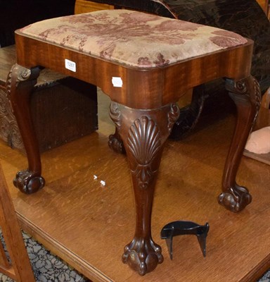 Lot 1287 - A 19th century carved mahogany dressing stool, on ball and claw feet, bearing label Christopher...