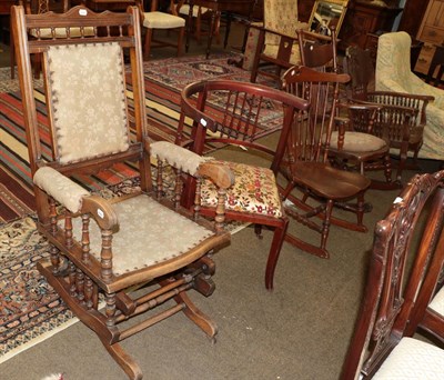 Lot 1295 - Three various 20th century country rocking chairs, each with spindle backs, an American rocking...