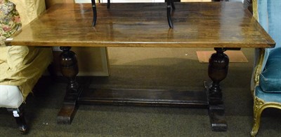 Lot 1318 - An oak refectory table, with cup and cover supports and trestle base