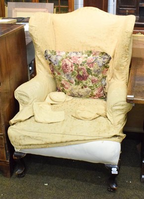 Lot 1319 - A Victorian wing backed armchair, late 19th century, in George III style, with removable loose...