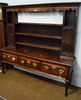 Lot 1330 - A George III oak dresser and rack, late 18th century, the upper section with a bold cornice above a