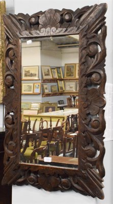 Lot 1332 - A 19th century rectangular mirror plate within a carved pierced oak frame