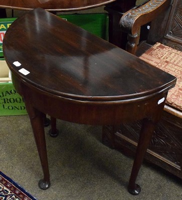 Lot 1337 - A George II mahogany fold-over demi-lune table, 74cm by 37cm by 73cm high