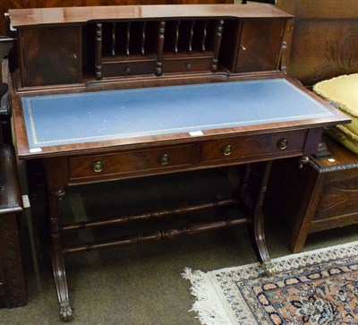 Lot 1342 - A reproduction mahogany leather inset writing table