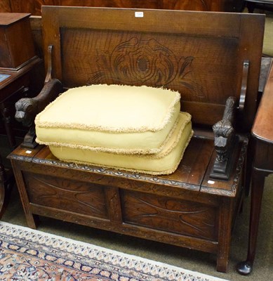 Lot 1343 - A carved oak monks seat