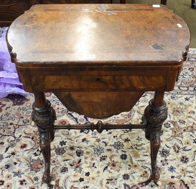 Lot 1344 - A Victorian walnut games/sewing table