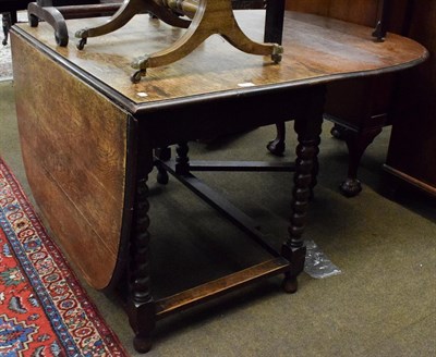 Lot 1359 - A oak drop leaf dining table with turned supports