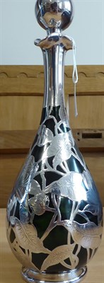 Lot 2022 - An Art Nouveau Sterling Silver Foliate Overlay Green Glass Decanter Bottle, by Henry Herbert...