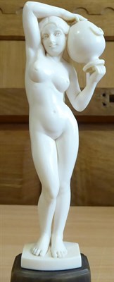 Lot 2027 - An Art Nouveau Carved Ivory Figure, circa 1910, of a nude maiden carrying a water urn, on a...