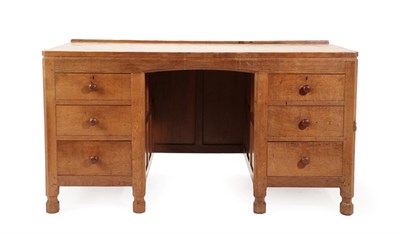 Lot 2043 - Robert Mouseman Thompson (1876-1955): An English Oak Panelled Kneehole Desk, 1930's, with...