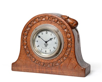 Lot 2047 - Robert Mouseman Thompson (1876-1955): An English Oak Mantel Clock, 1930's, the circular case...