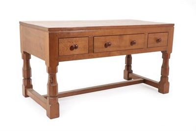 Lot 2049 - Robert Mouseman Thompson (1876-1955): An English Oak Table/Desk, 1940's/50's, the three plank...