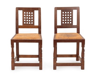 Lot 2052 - Robert Mouseman Thompson (1876-1955): Two English Oak Lattice Back Dining Chairs, 1940's/50's, with