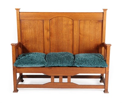 Lot 2094 - An Arts & Crafts Oak Hall Bench/Settle, with capped uprights and feet, panelled back and...