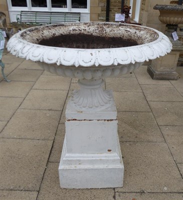 Lot 1100 - A large Victorian white painted cast iron garden urn decorated with egg and dart borders and raised