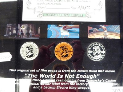 Lot 3031 - James Bond 007 The World Is Not Enough Original Film Props a framed set consisting of three...